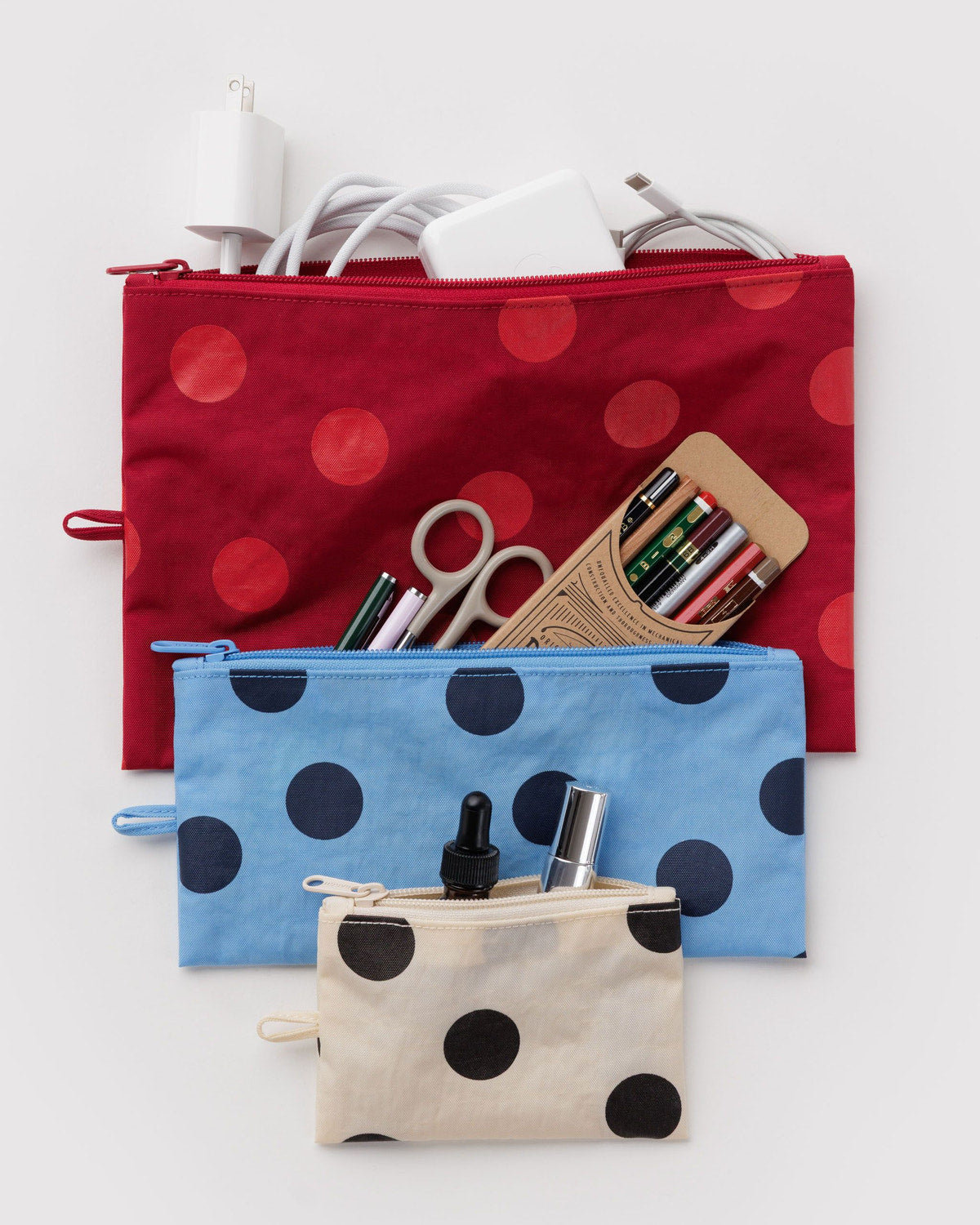Set of three flat zip pouches with polka dots: red, blue, and cream