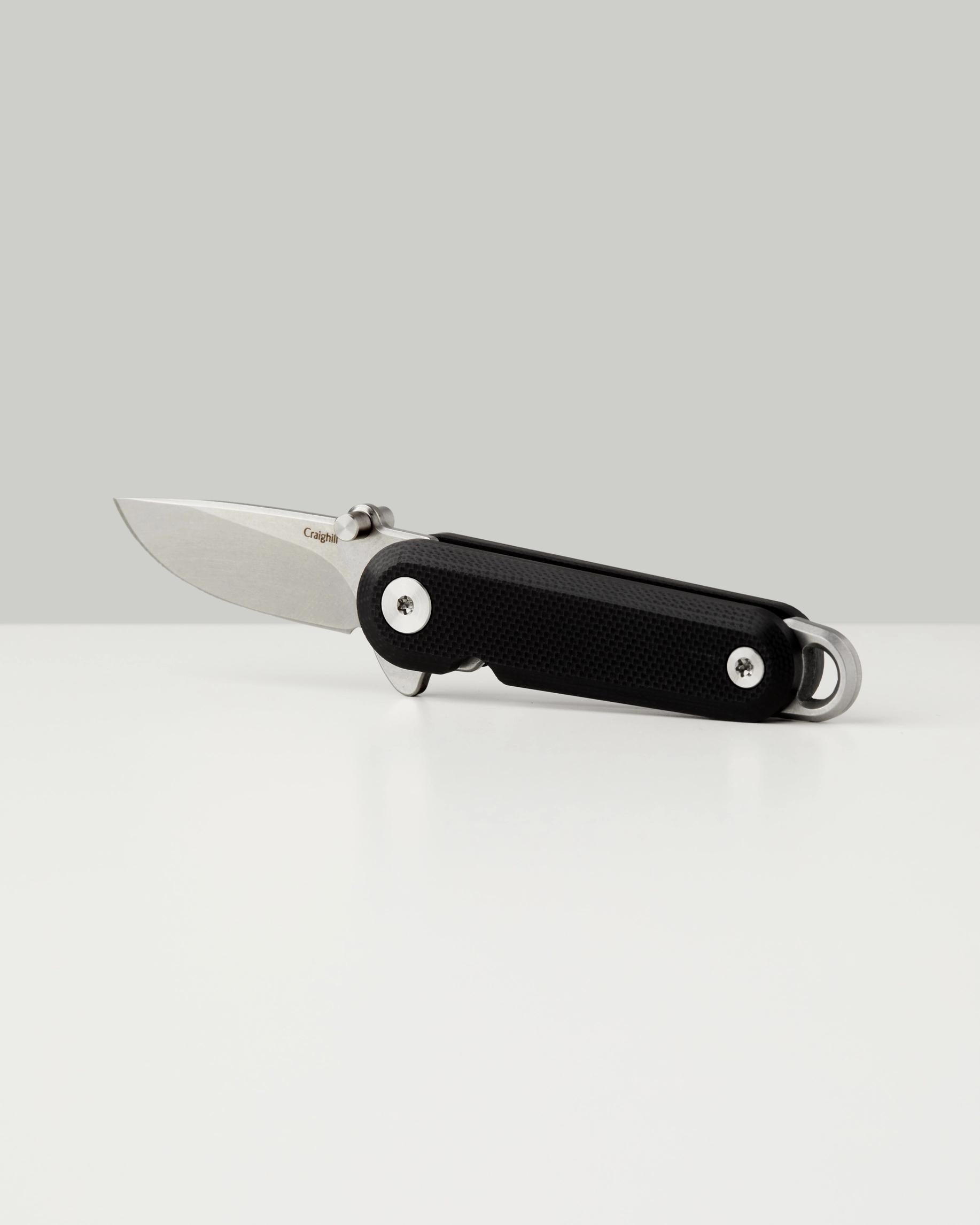 G10 Lark folding knife with black textured grip, stainless blade, silver screws and pivot