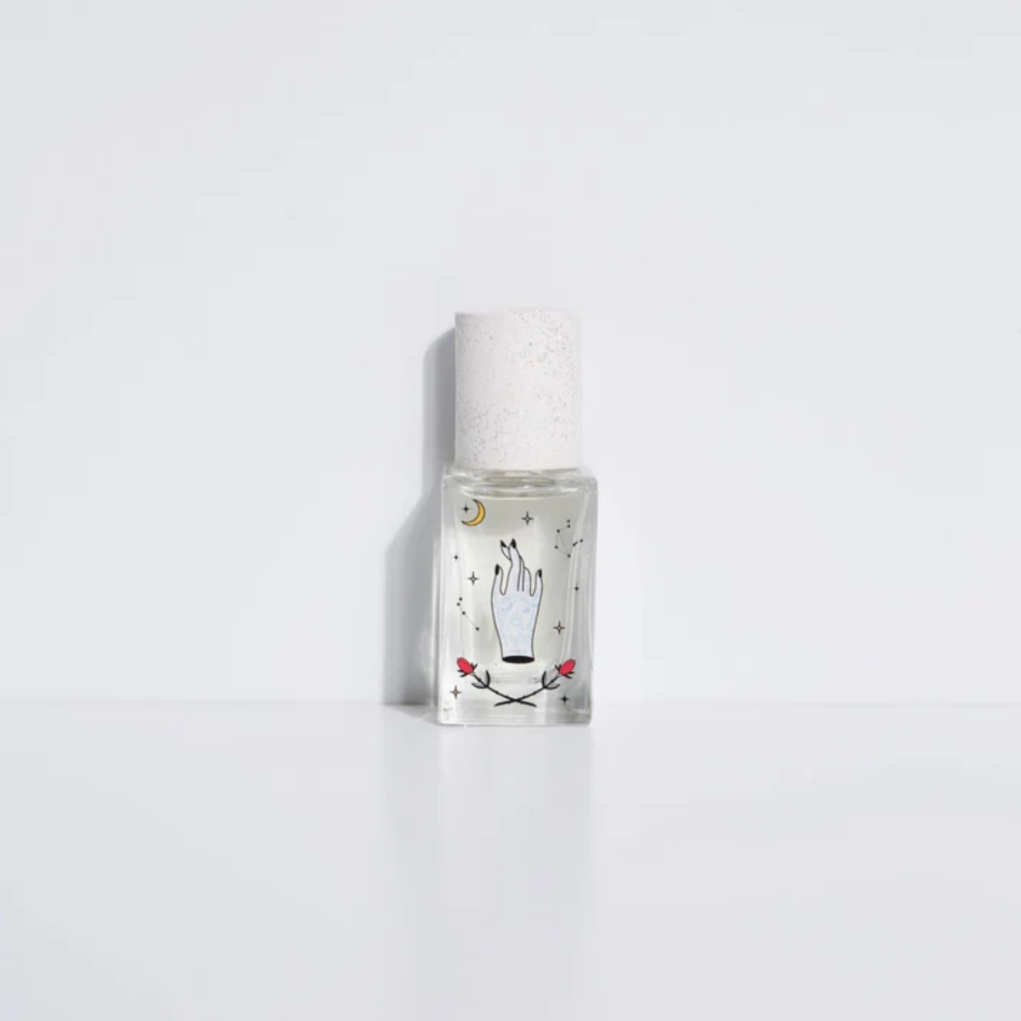 Clear eau de parfum bottle with frosted cap and illustrated label, spray top