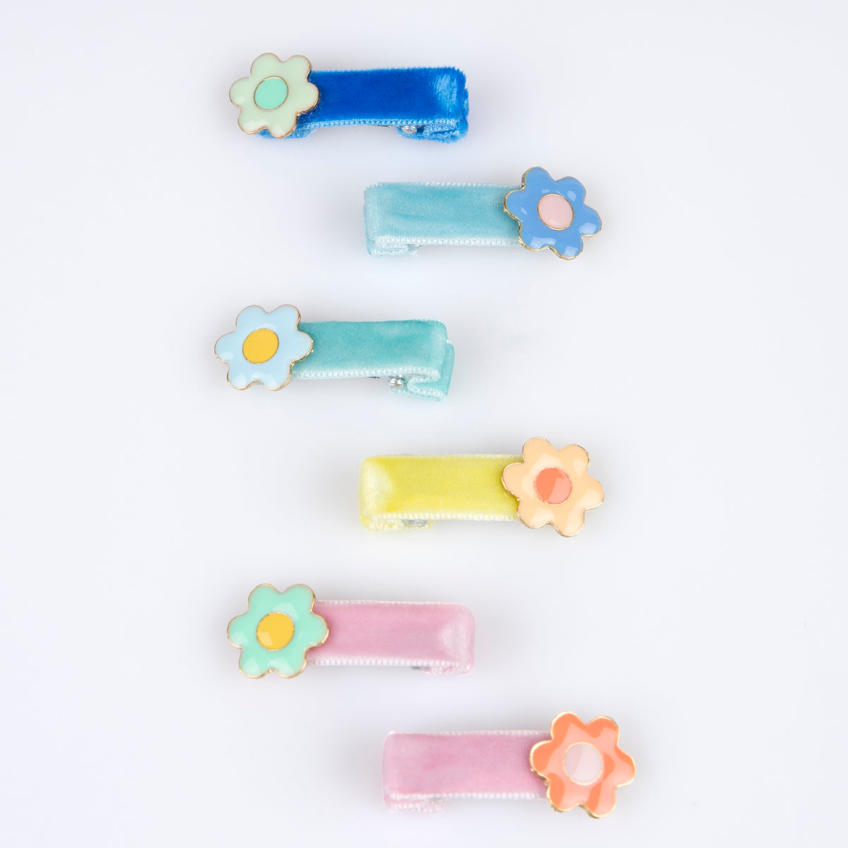 Pastel enamel flower hair clips, flat lay with multiple colors.