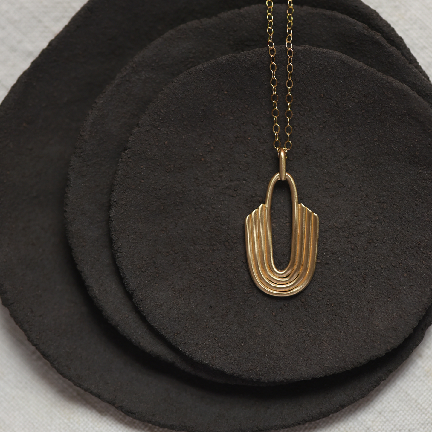 Gold inverted arch brass pendant necklace on a fine chain, U-shaped layered charm