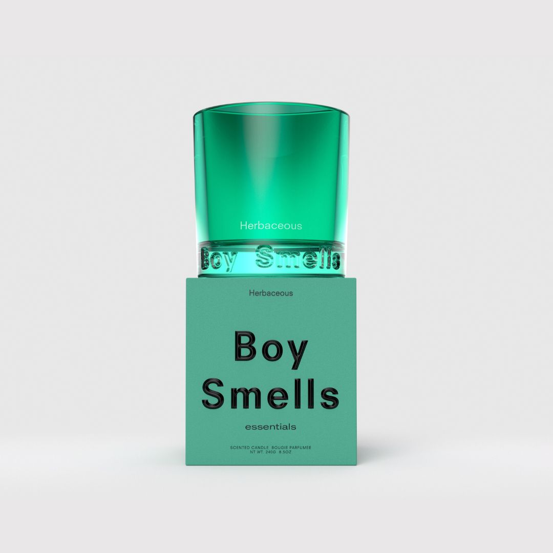 Green glass candle in teal jar with 'Herbaceous' and 'Boy Smells' label