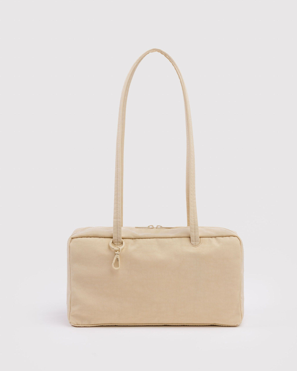 Cream nylon bowler bag with top zipper and looped carry handles
