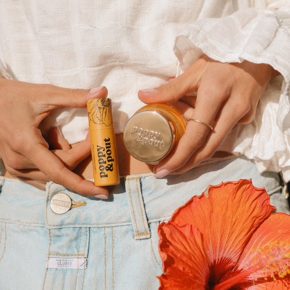 Lip care duo use: hands holding Wild Honey balm jar and lip scrub tube