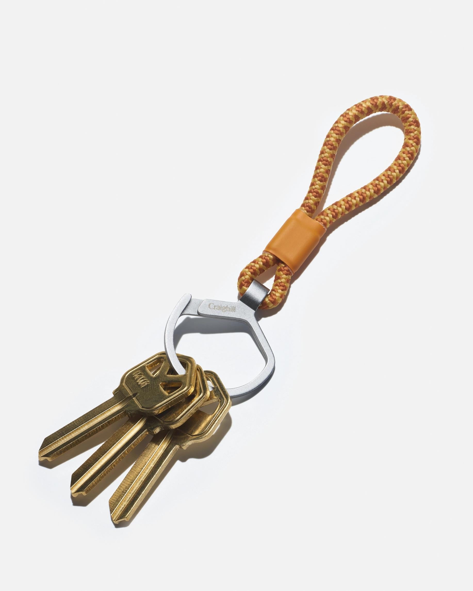 Metal split ring key holder on orange braided rope loop