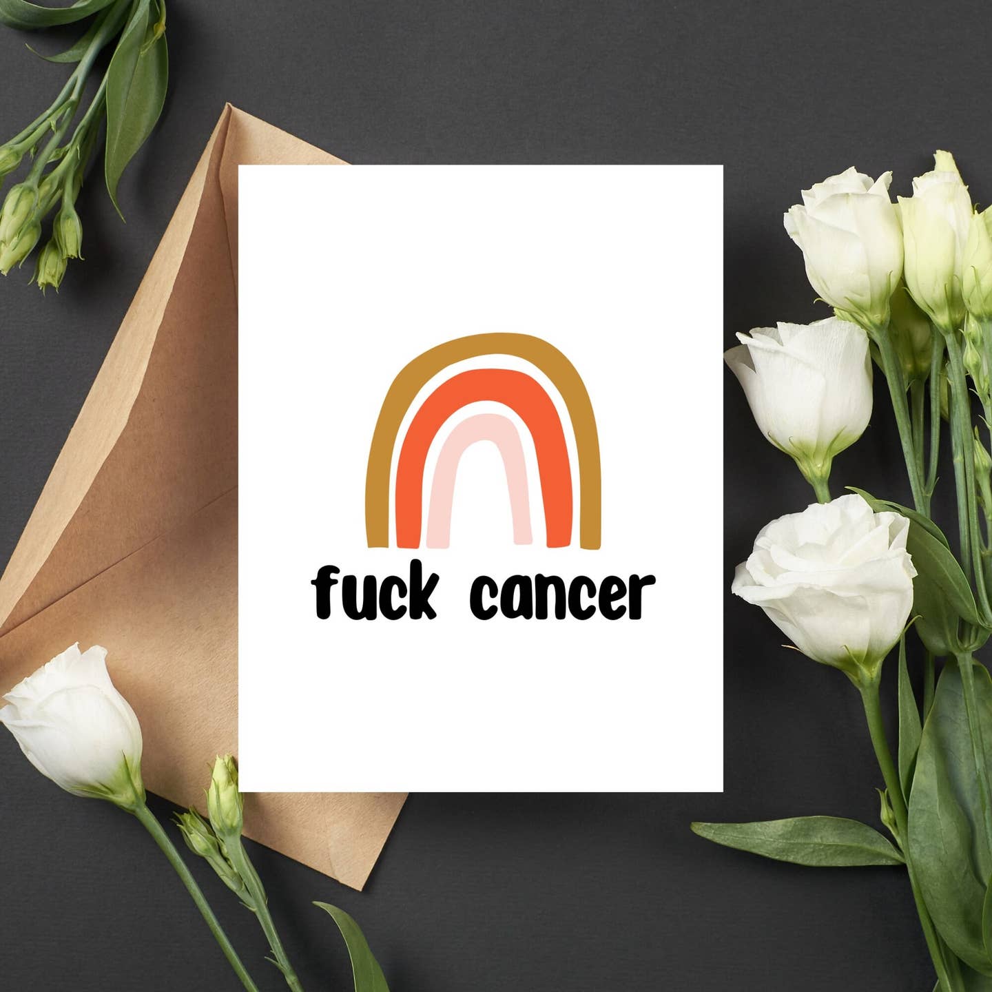 White greeting card with rainbow arch graphic and "fuck cancer" message