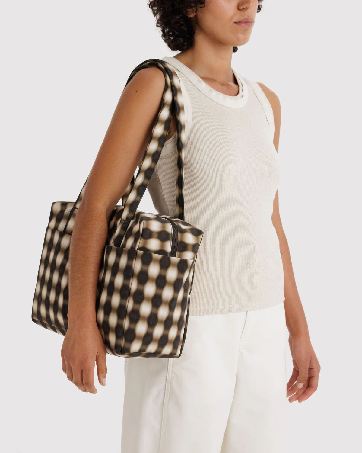 Black-and-cream check cloud tote bag carried by handles