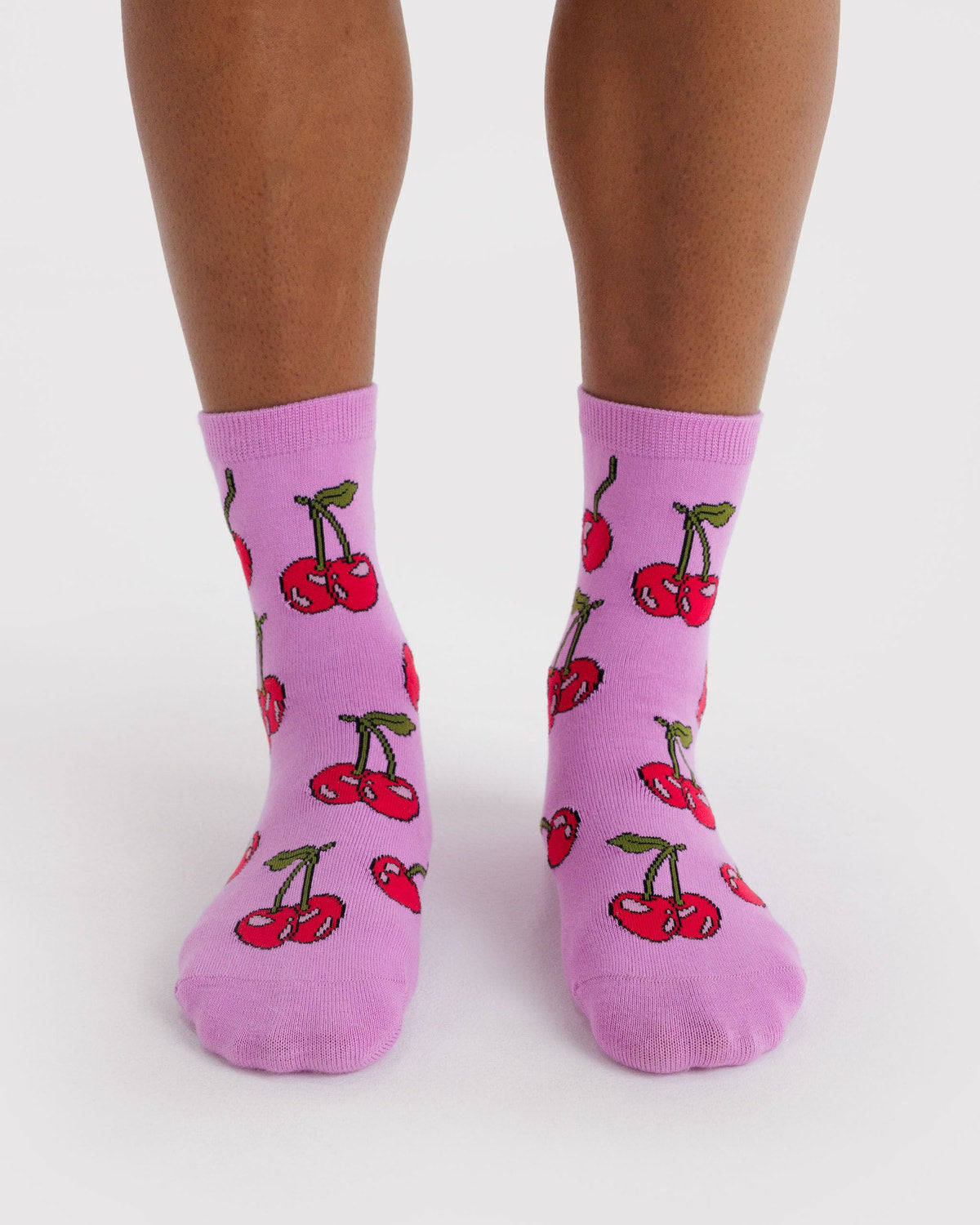 Crew-length socks in lavender with red cherry fruit pattern, two-pack view.