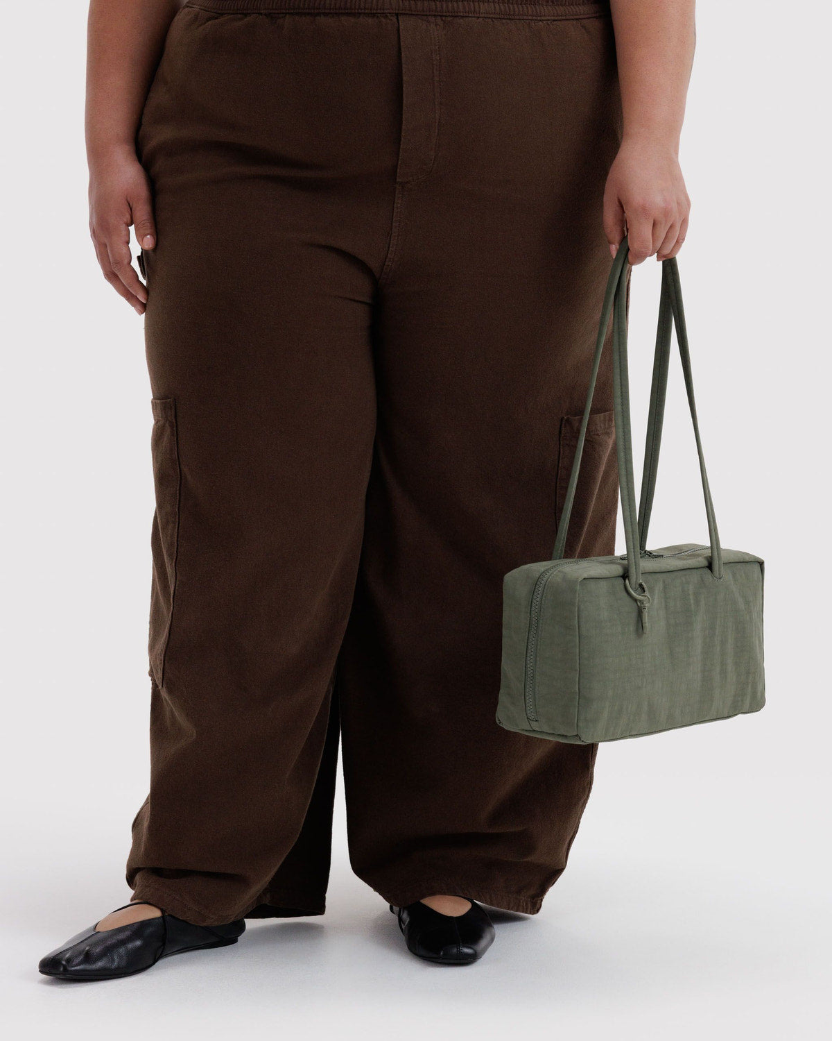 Olive green nylon bowler bag with top handles and zip closure