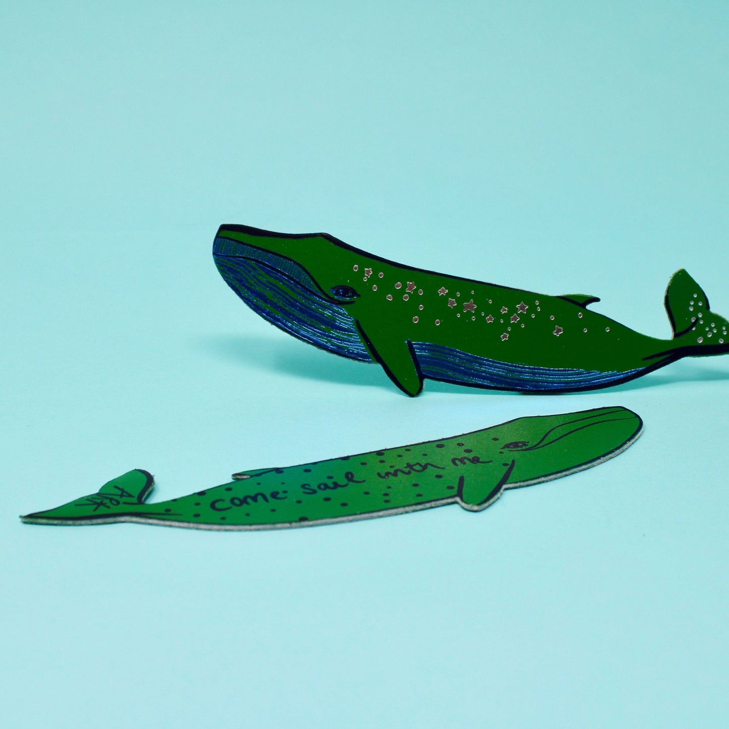 Green whale leather bookmark with dotted spots and curving fin shape