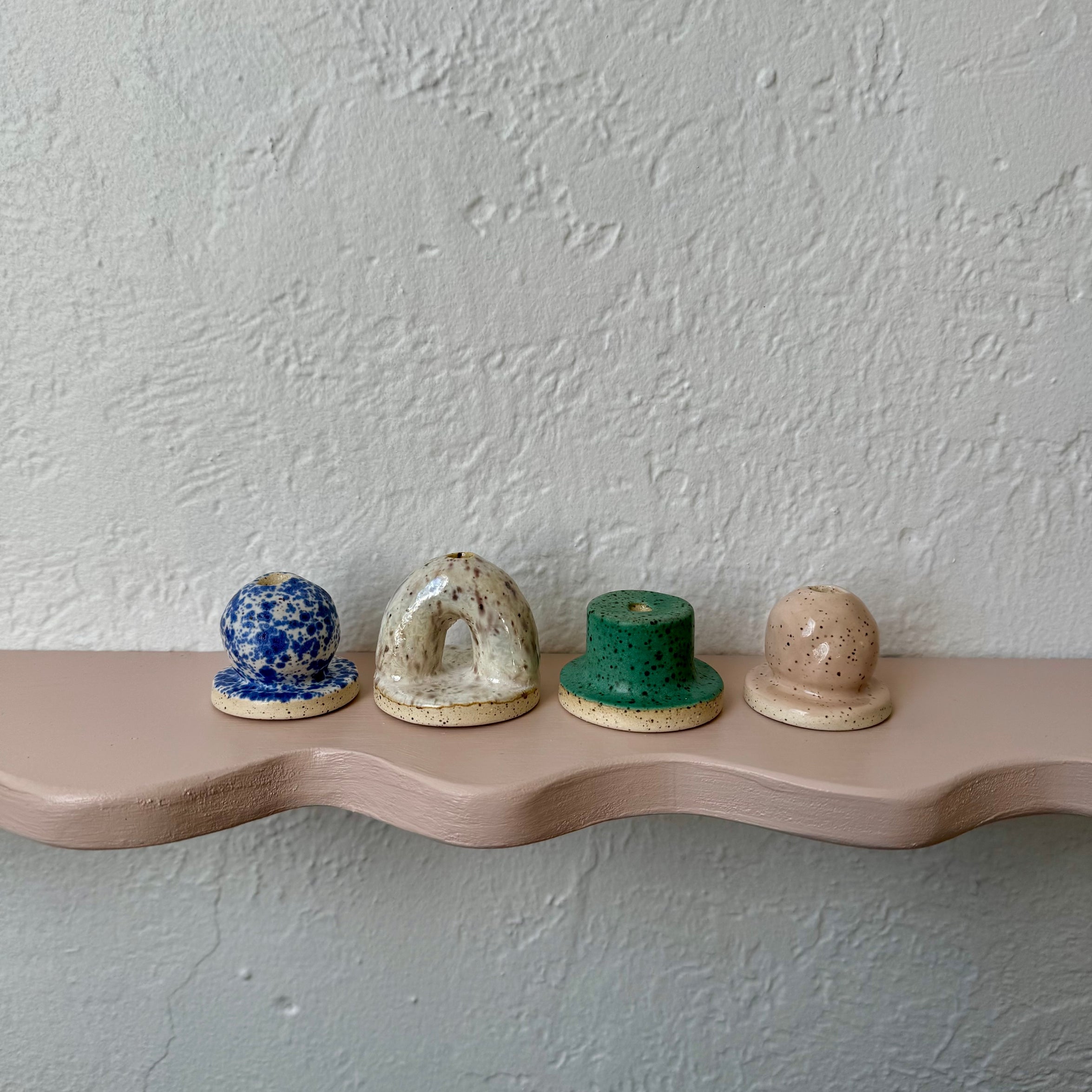Ceramic arch incense holder display with blue, beige, green, and tan speckled domes