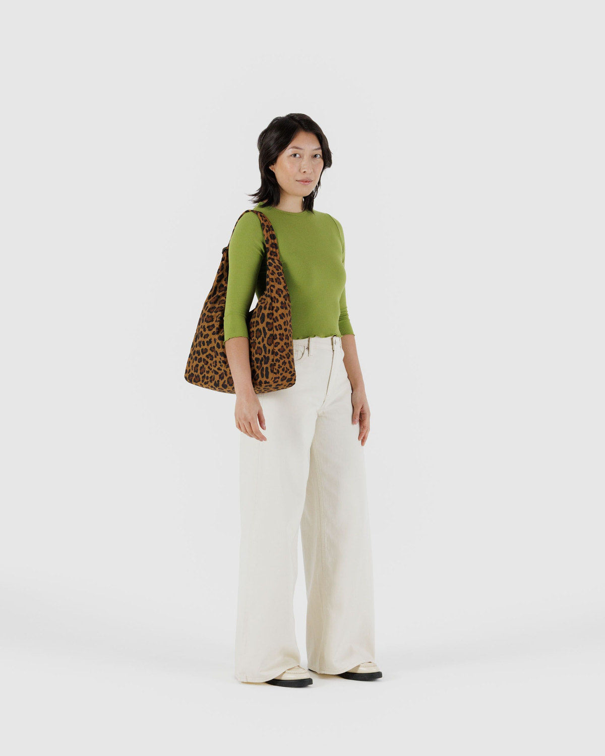 Leopard print nylon shoulder bag worn on the shoulder.