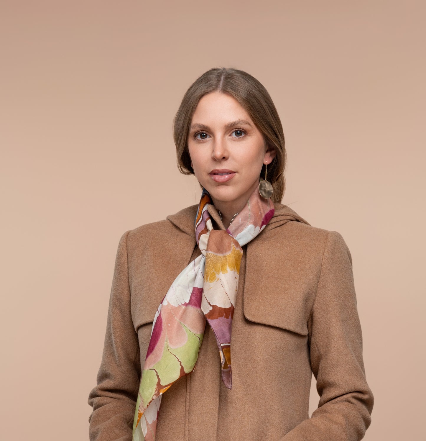 Marbled scarf worn with abstract lip-like wavy pattern in maroon, blue, yellow, cream