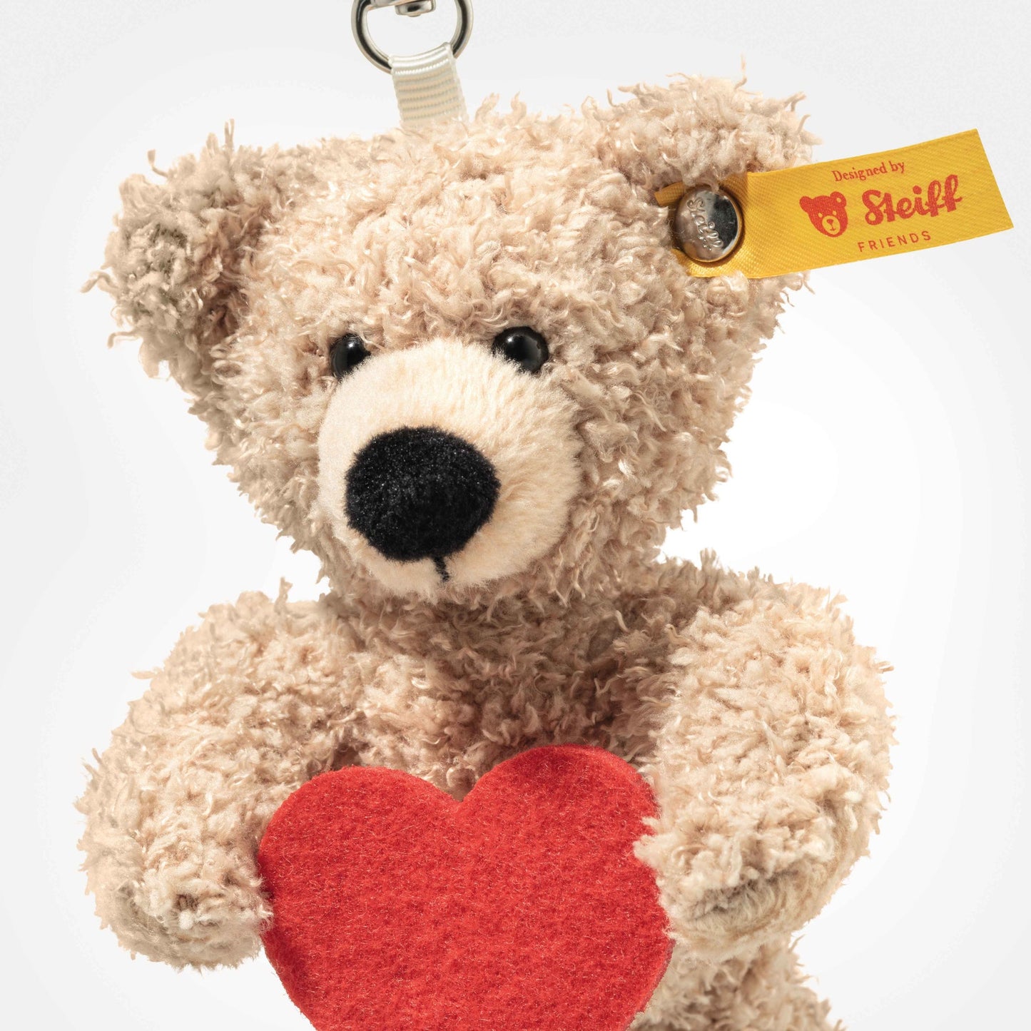 Beige teddy bear keyring with red heart applique, detailed face, metal clip loop