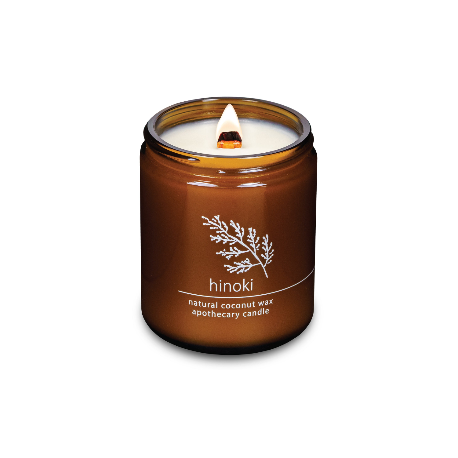 Amber coconut wax candle in glass jar, wick lit, labeled Hinoki