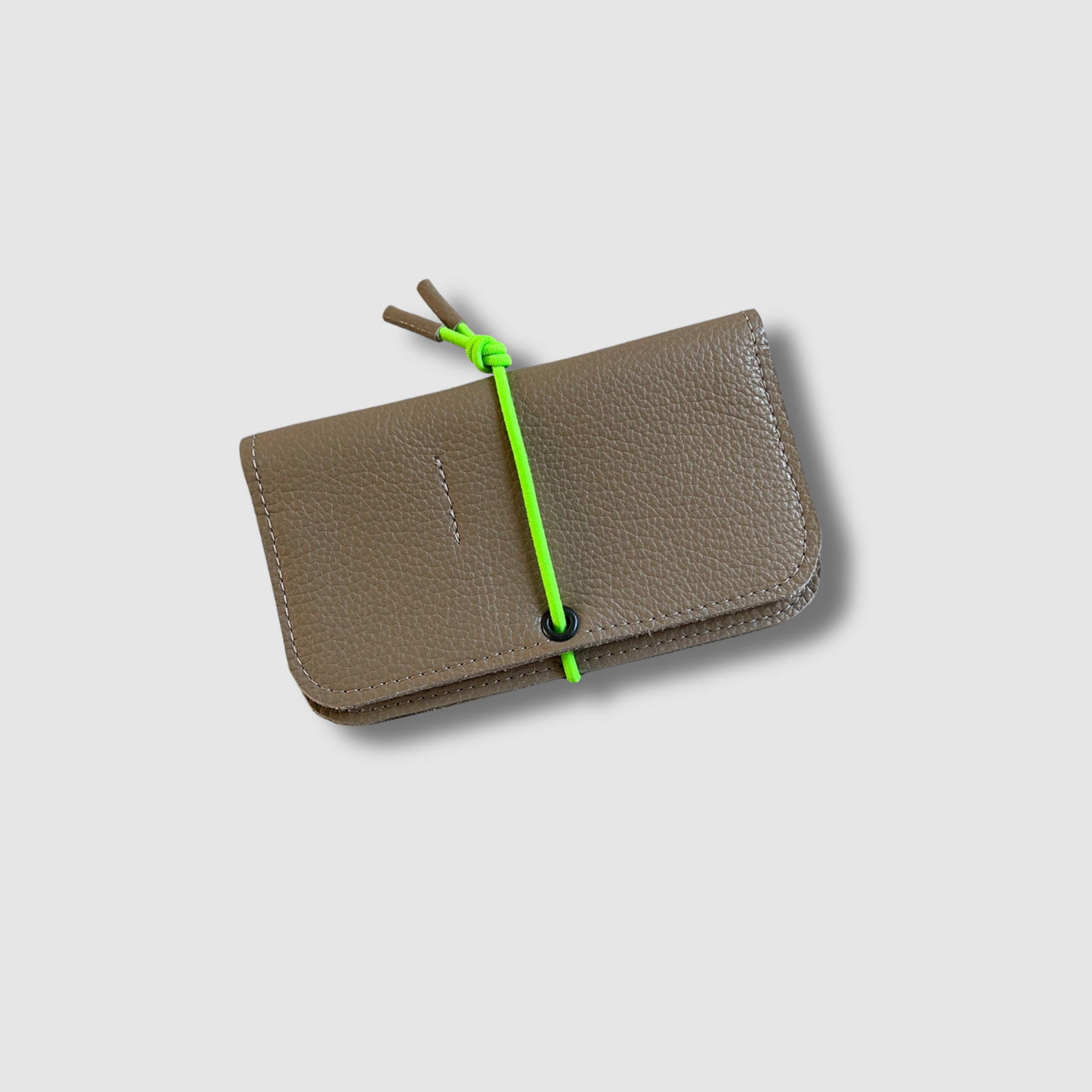 Taupe leather knot wallet with front flap and neon green cord tie, textured leather