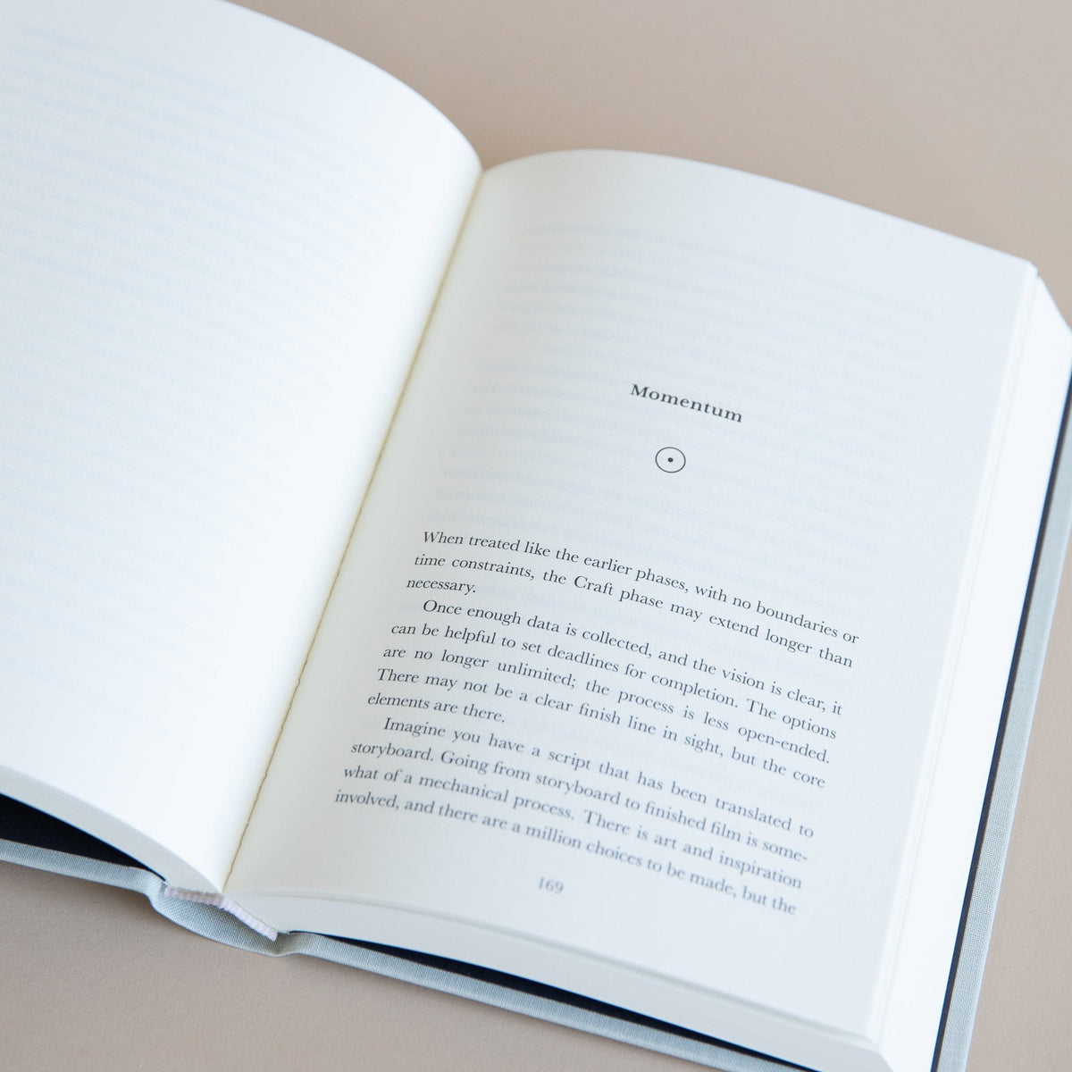 Open hardcover book with printed pages and black text on cream paper, spine visible