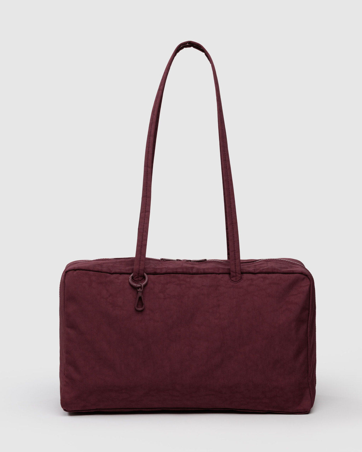 Medium nylon bowler bag in burgundy with top zipper and double carry handles.