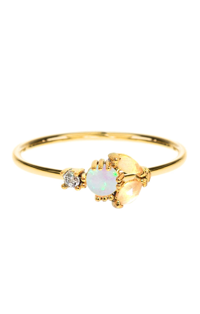 Gold-tone ring with iridescent opal-style center, cat's eye detail, and small CZ accents