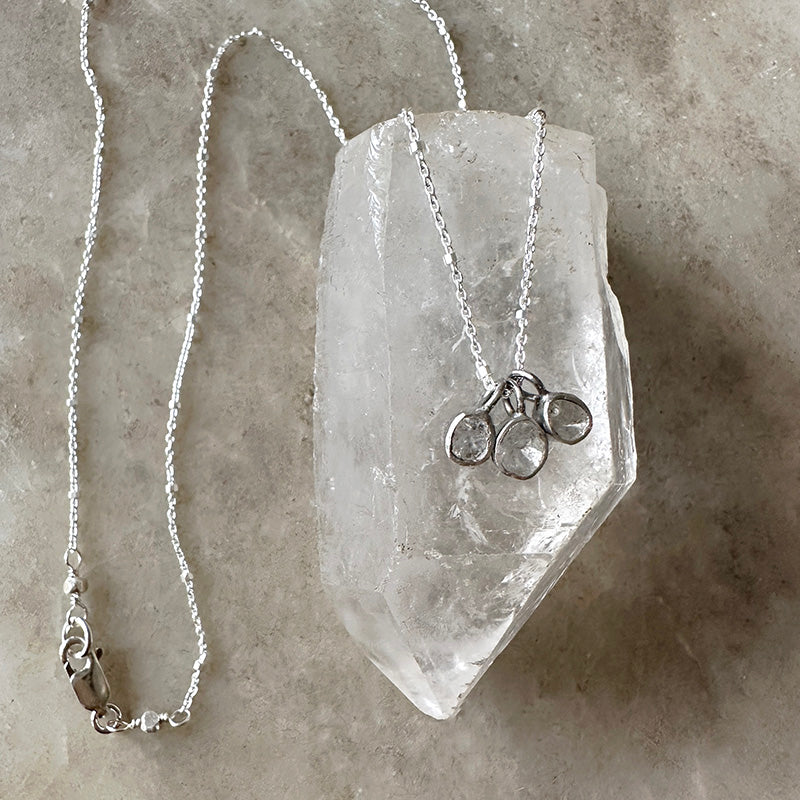 Sterling silver necklace with three round diamond-style drops on a fine chain