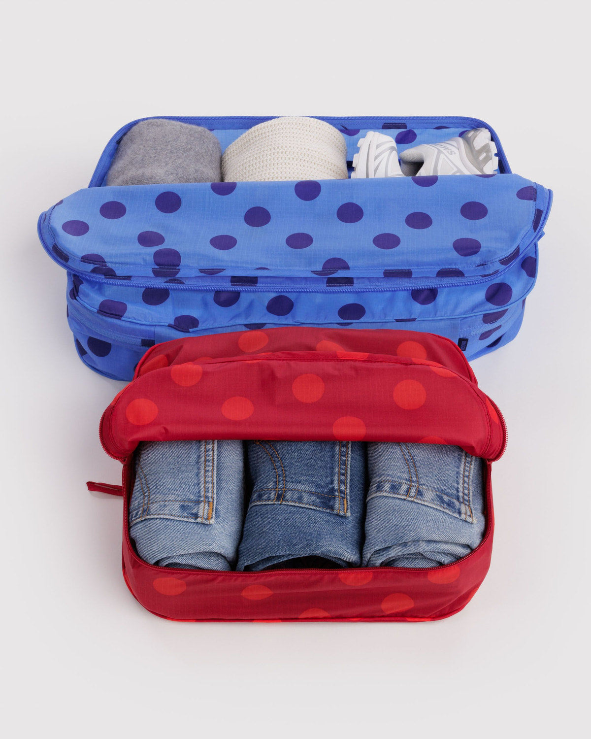 Large packing cubes with polka-dot fabric, zip closures, open with denim inside
