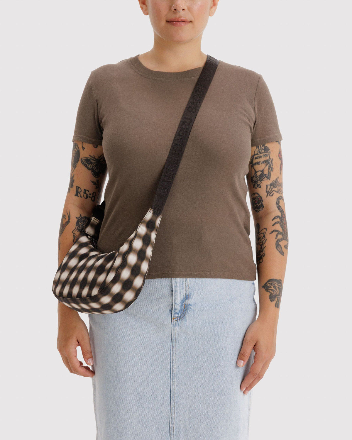 Small nylon crescent bag with black and cream gingham pattern and dark strap