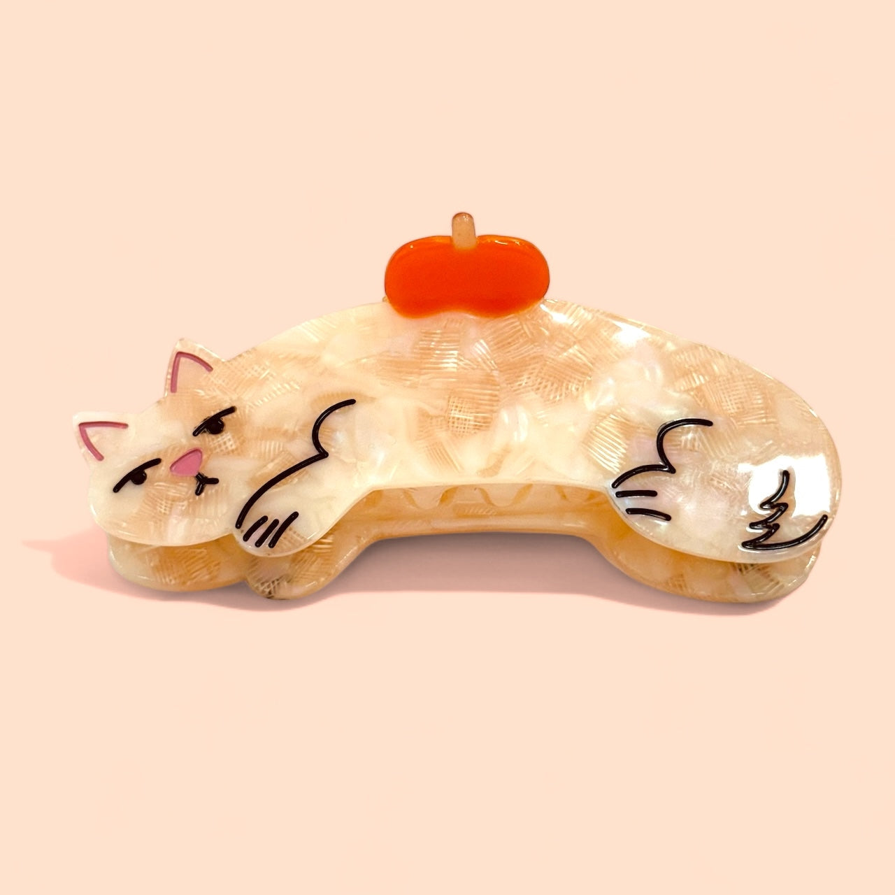 Cream cat hair claw with orange top clip and cartoon kitty face detail