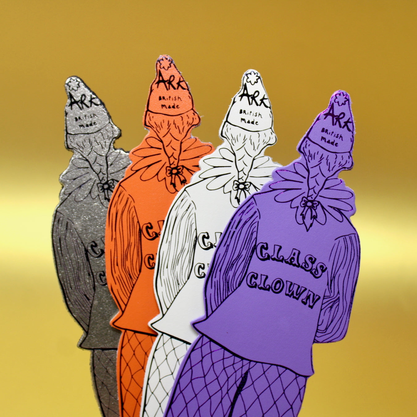 Clown-shaped leather bookmark with lilac and orange jester artwork on flat cutout