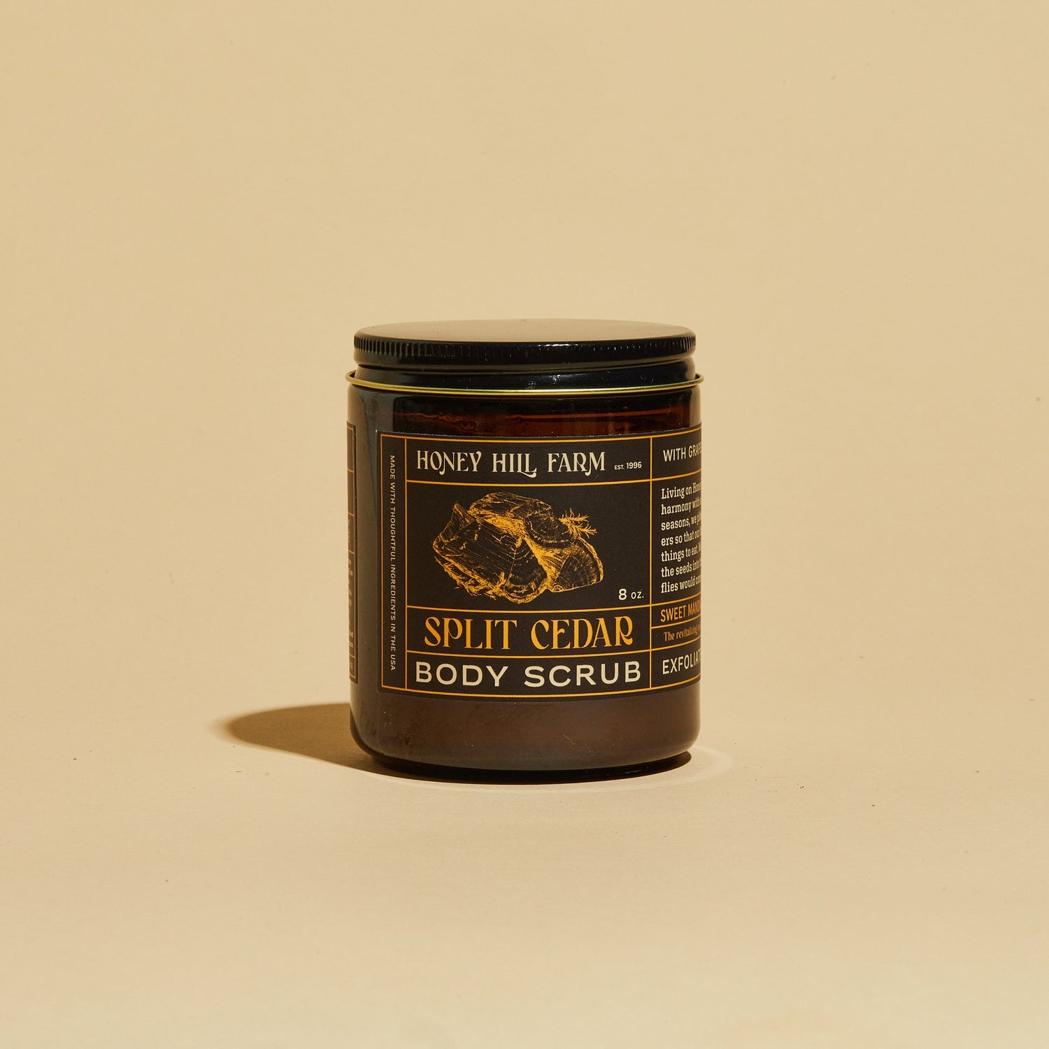 Split Cedar body scrub jar with black lid and honeycomb label