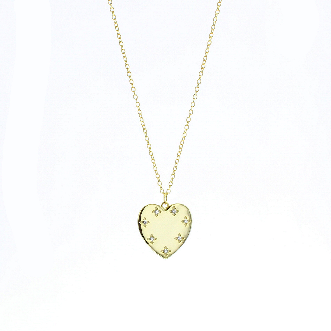 Gold heart pendant necklace with small star accents