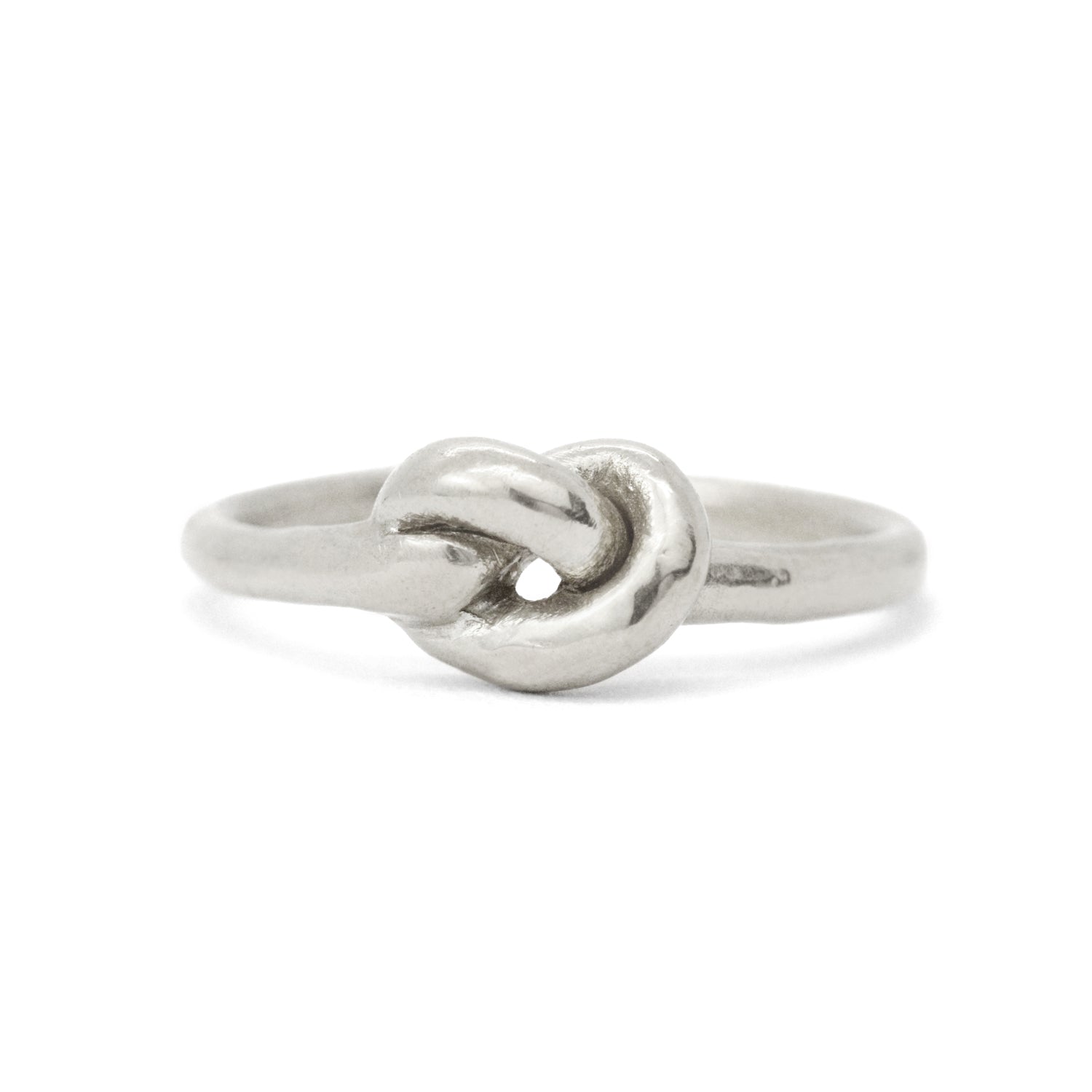 Silver ring with twisted heart-knot detail on smooth metal band