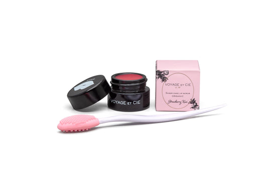 Strawberry sugar lip scrub set with pink jar, black lid, applicator brush, and pink pouch