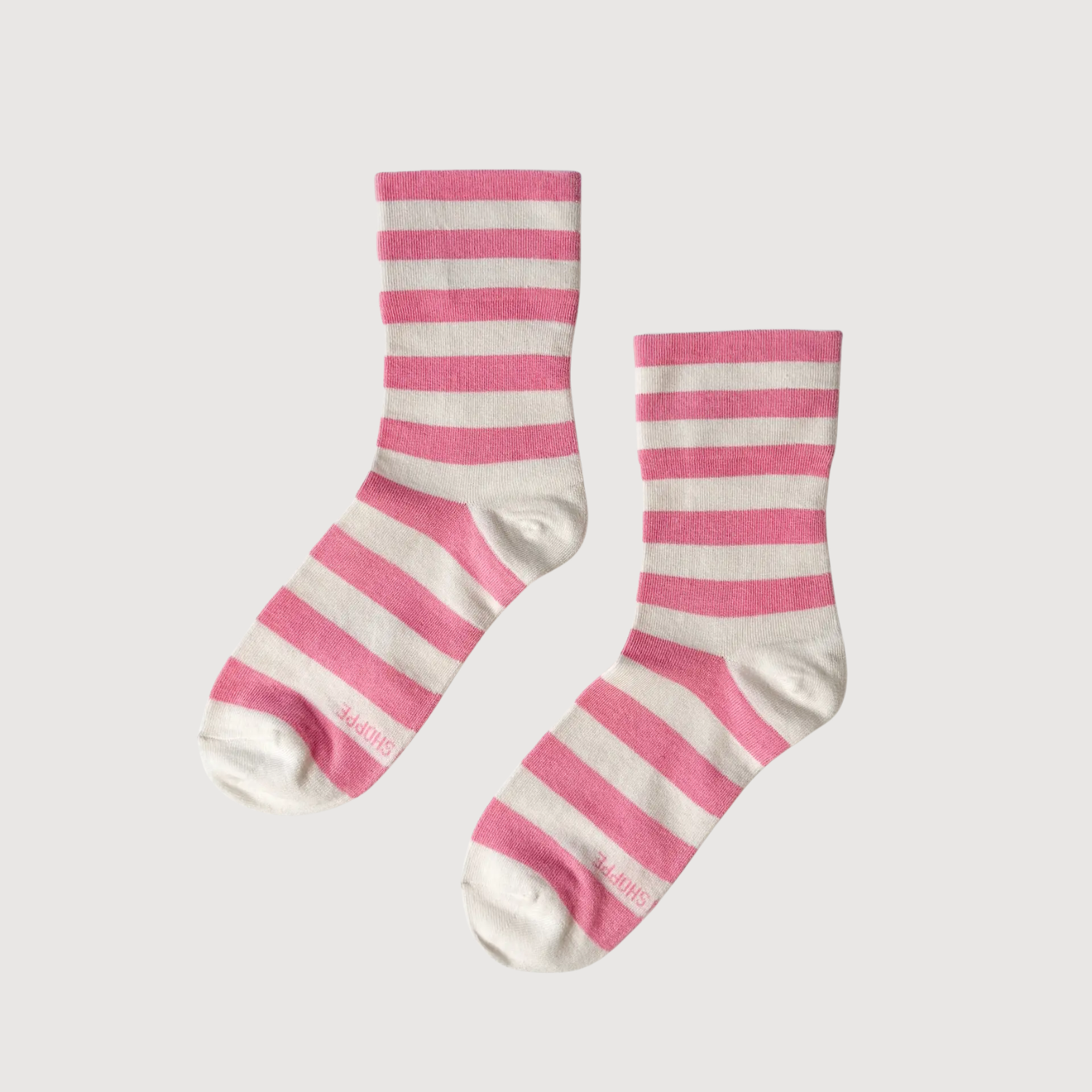 Pair of pink-and-white striped crew socks with ribbed cuffs.