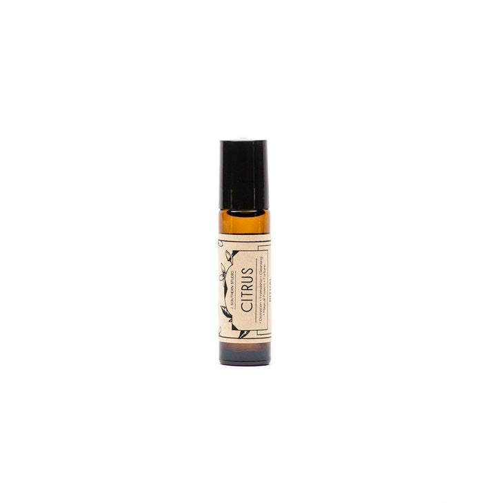 Citrus body oil in 10 ml glass bottle with black cap and amber liquid