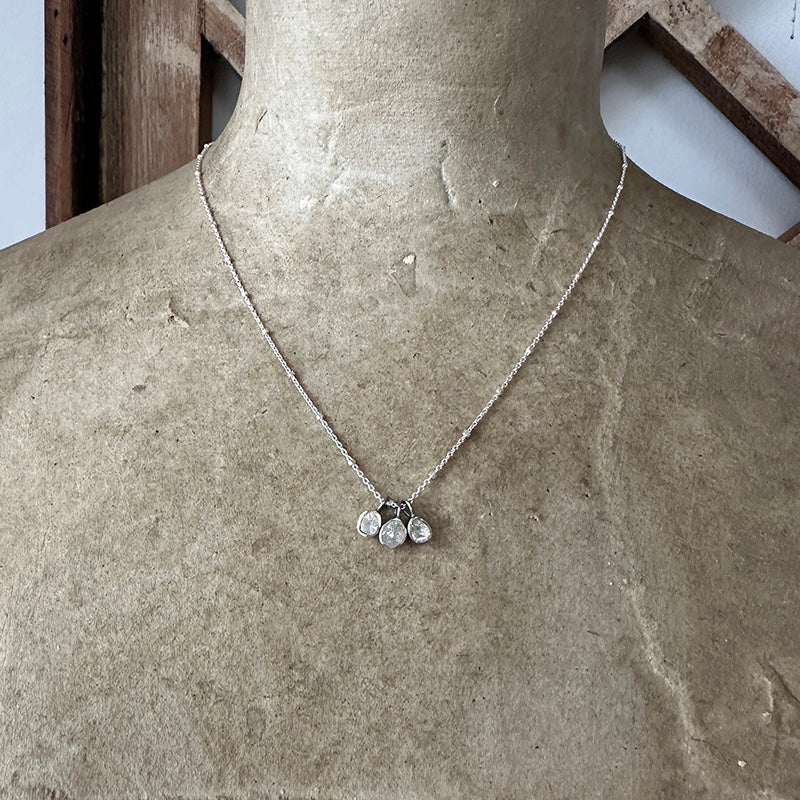 Sterling silver chain necklace with three small round drops at center