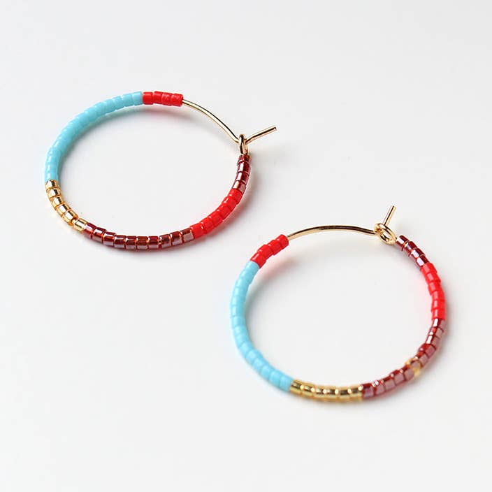 Beaded hoop earrings in turquoise and red with gold posts, shown as a pair.
