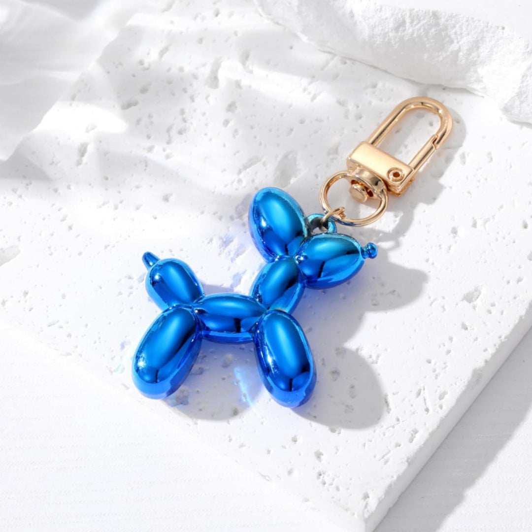 Blue metallic balloon dog keychain with gold clasp and split-ring attachment