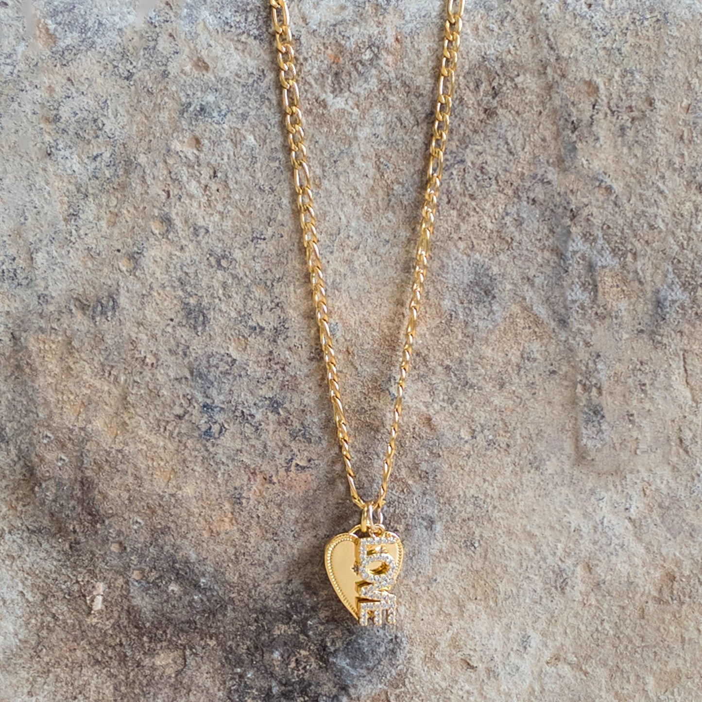 Gold link chain necklace with small heart charm and sparkle detailing