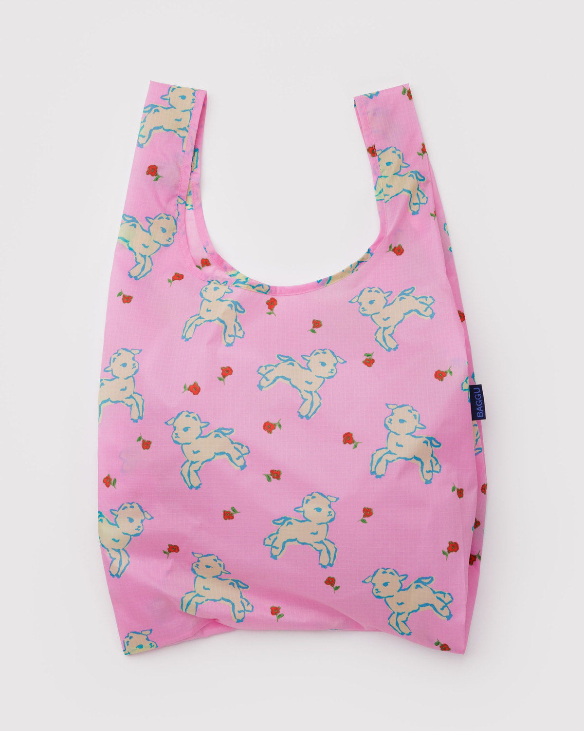 Reusable tote bag in pink with colorful fairy/pony print and short U-shaped handles.