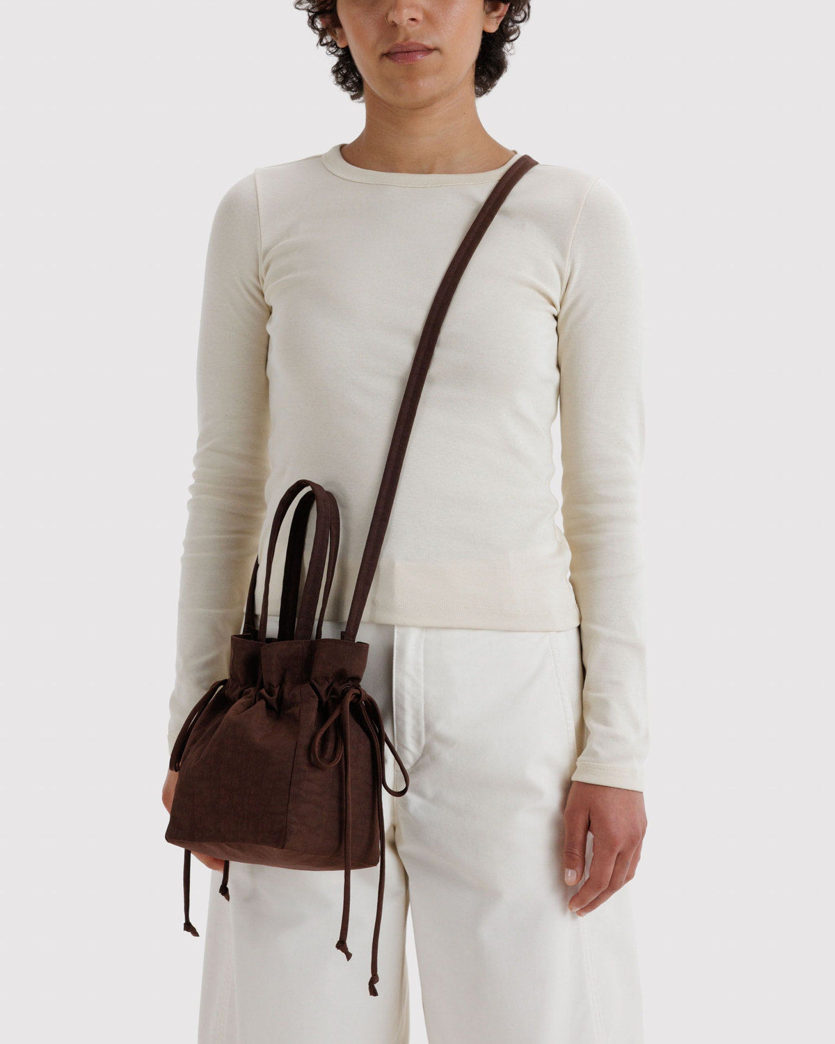 Brown nylon drawstring bag with ruched top and long cord drawstrings