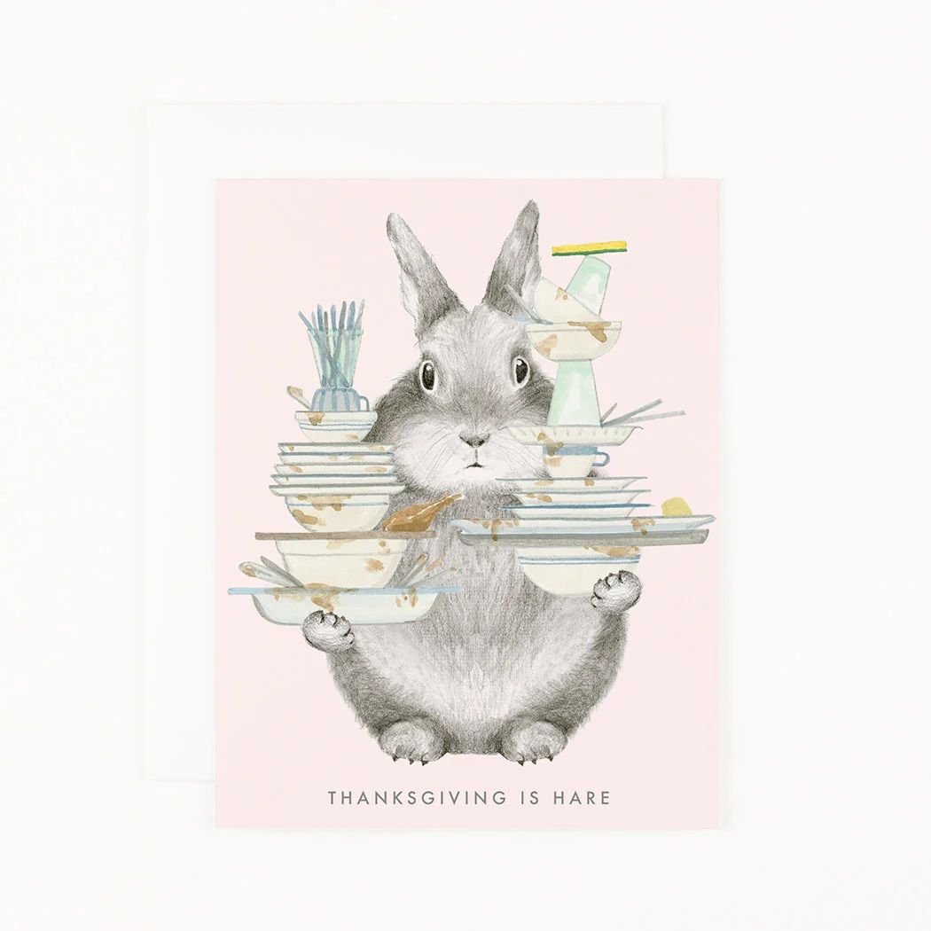 Thanksgiving hare greeting card with gray rabbit holding pastel stacked plates and cups