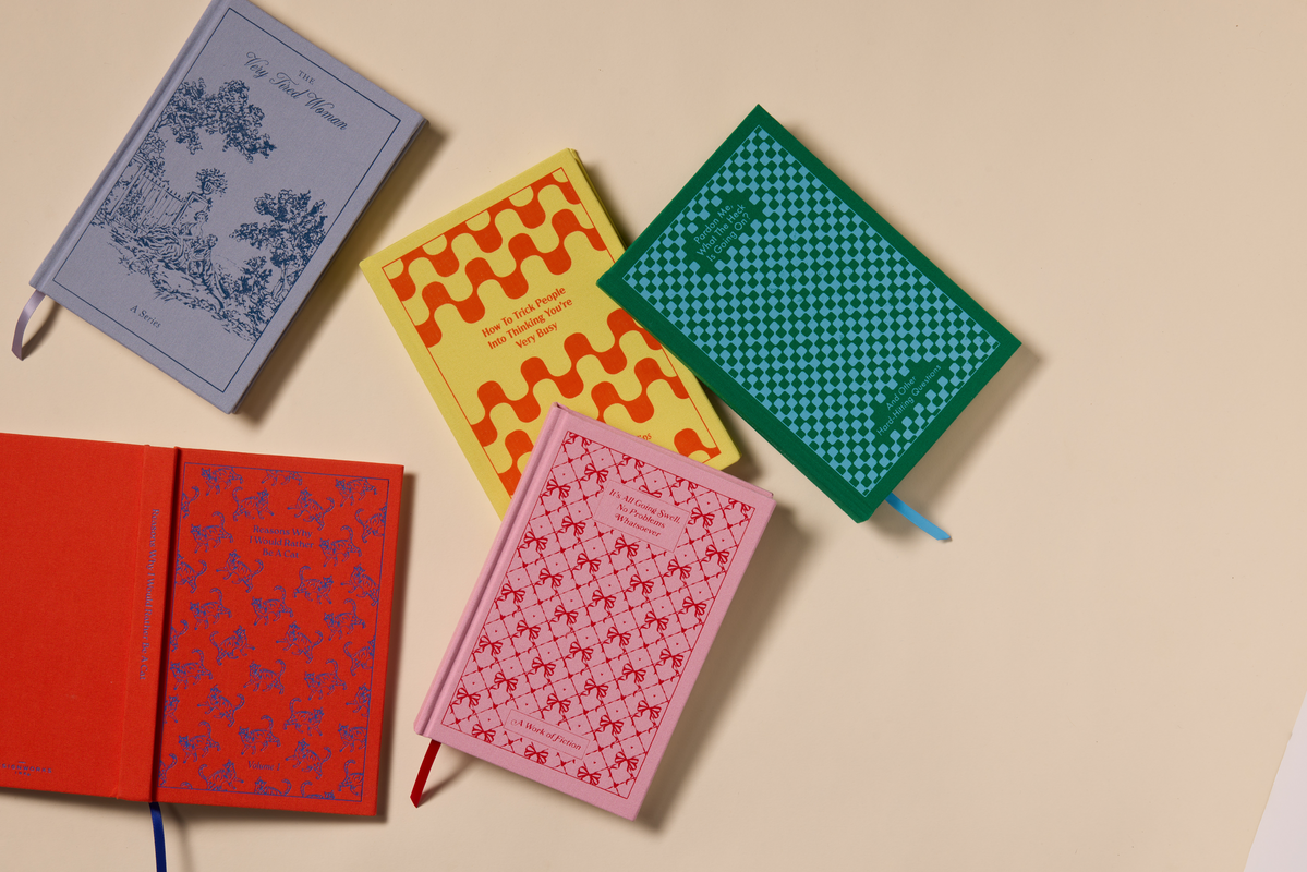 Five patterned notepads with covers in blue, yellow, teal, red, and pink colors