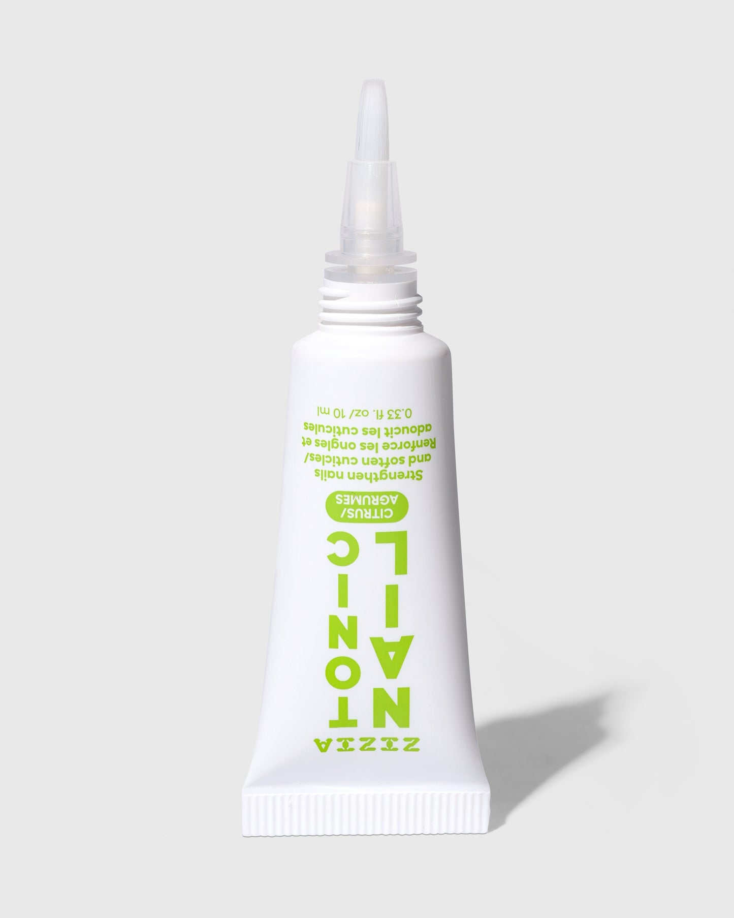 White cuticle oil squeeze tube with narrow dispensing tip and green label text.