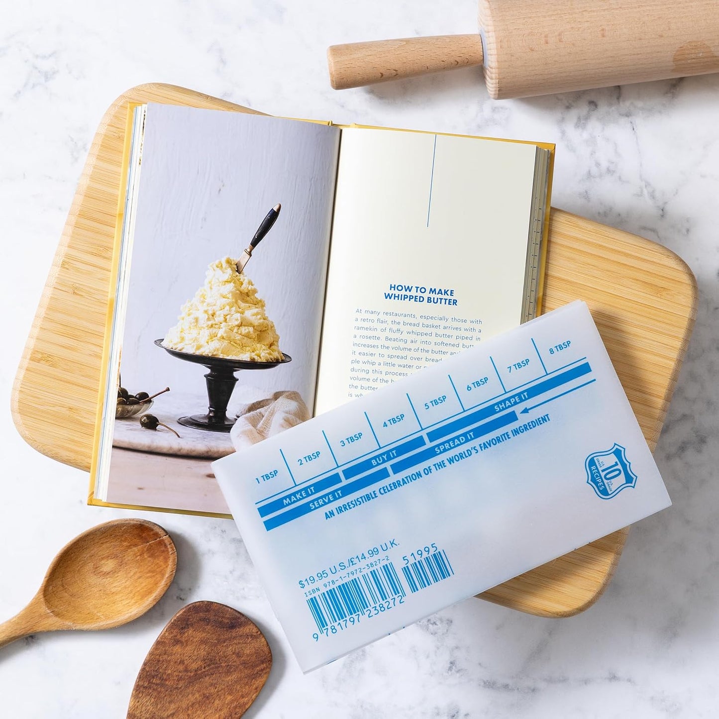 Open The Butter Book cookbook pages with food photo and recipe layout, plus leaflet.