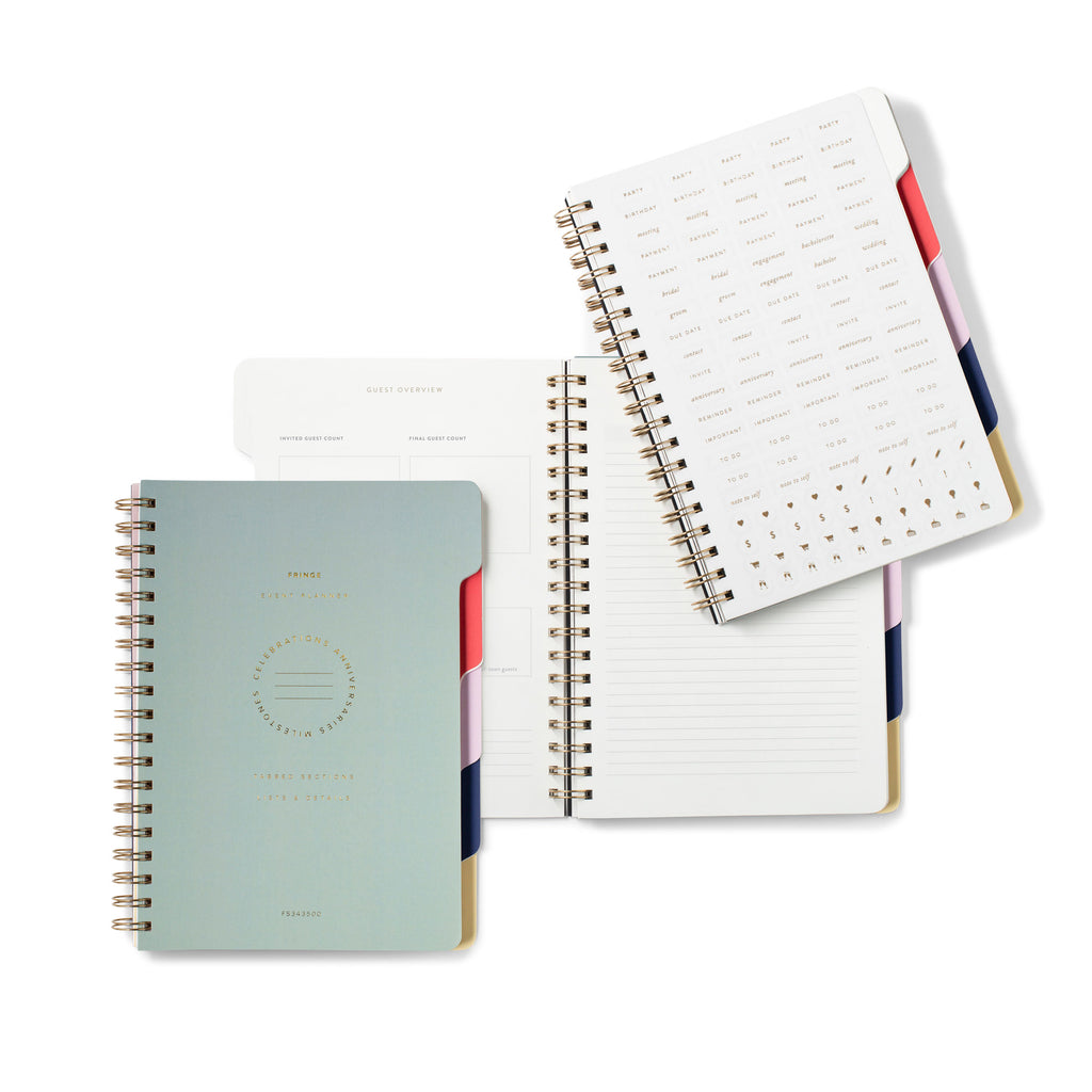 Set of spiral-bound color-block event planners with open lined pages and gold rings
