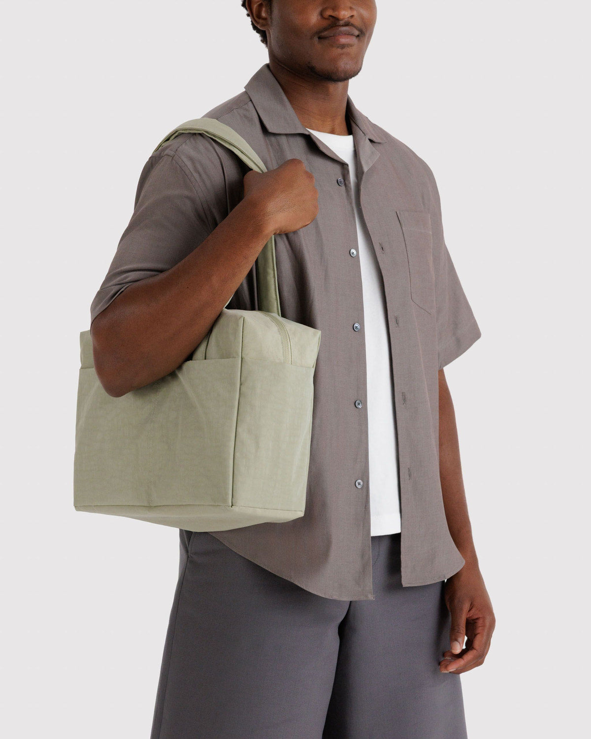 Light green cloud tote bag carried over shoulder, two top handles