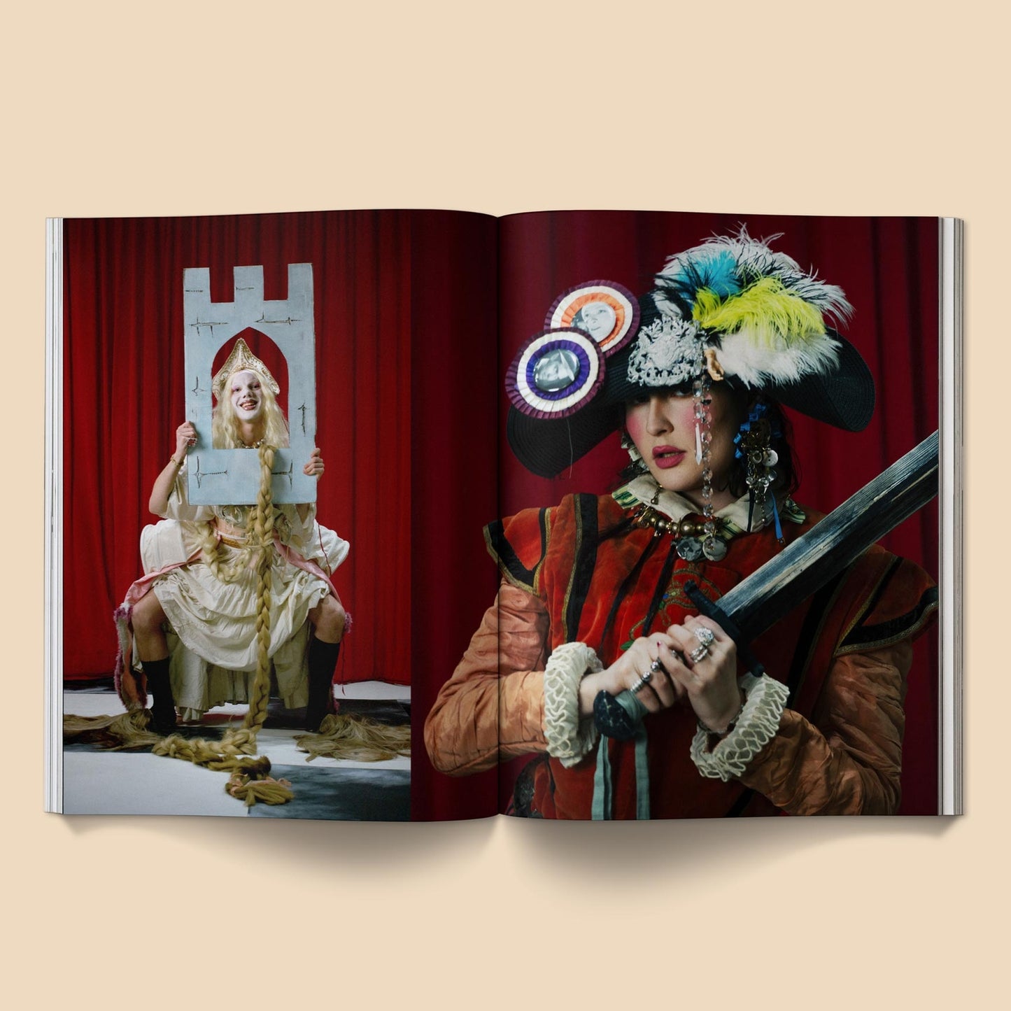 Open magazine spread with two people in elaborate costumes and feathered headwear
