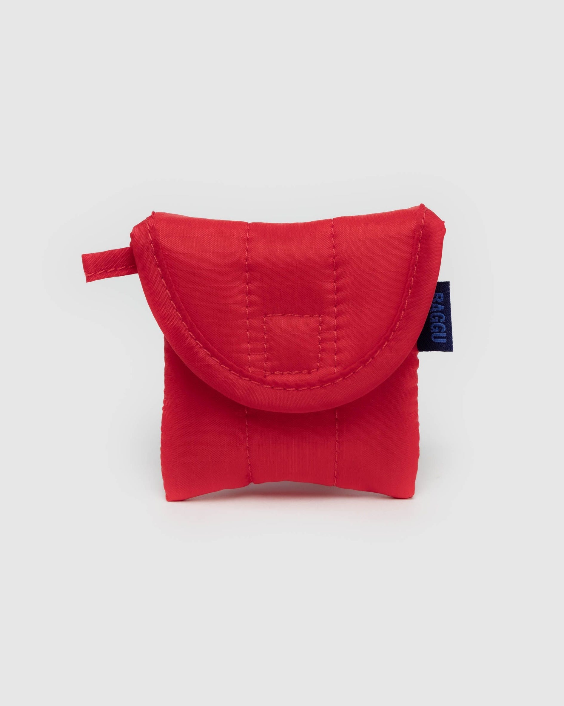 Puffy earbuds case in solid red fabric with a padded half-moon flap