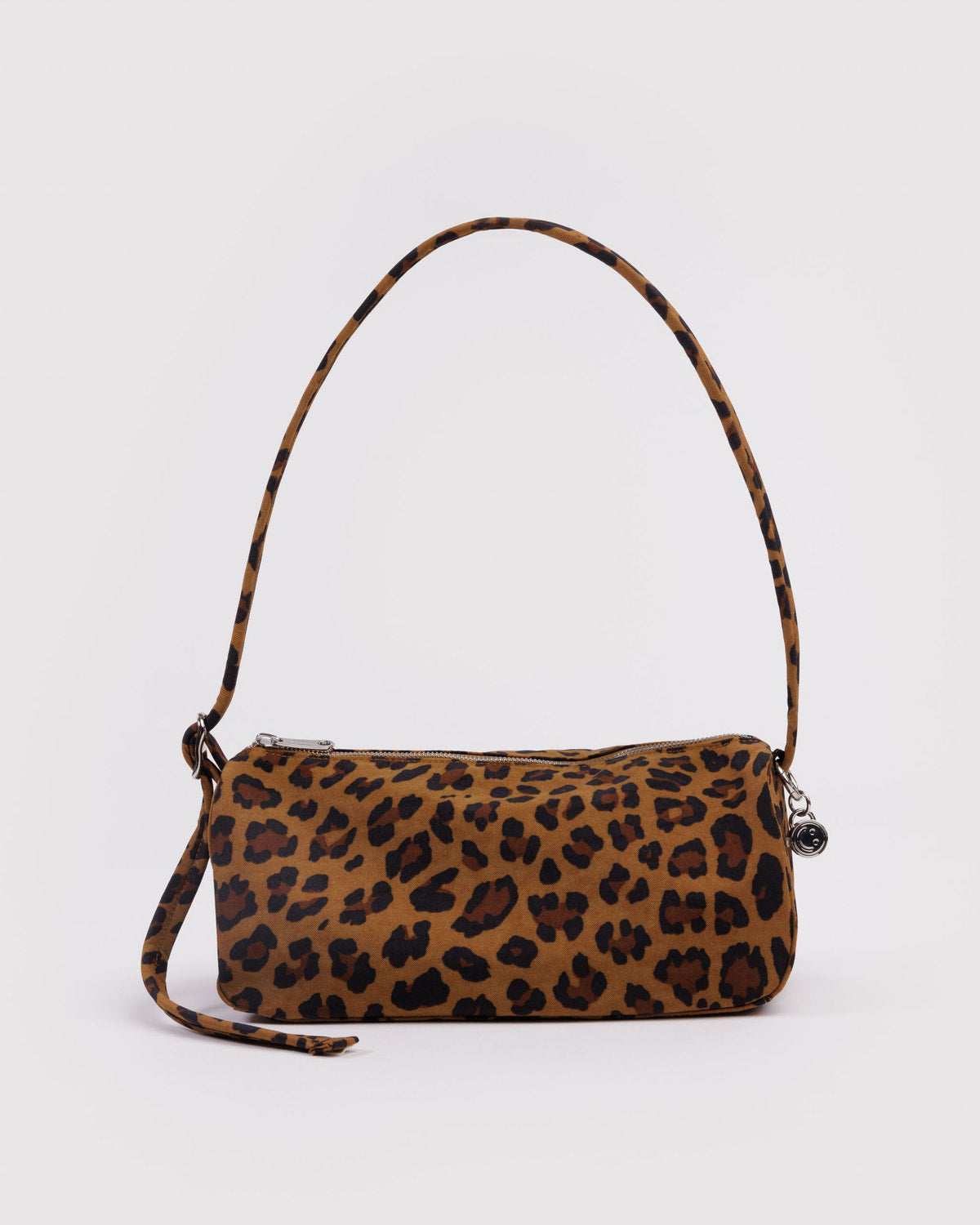 Leopard print nylon loaf bag with curved top handle, side strap, and top zipper.
