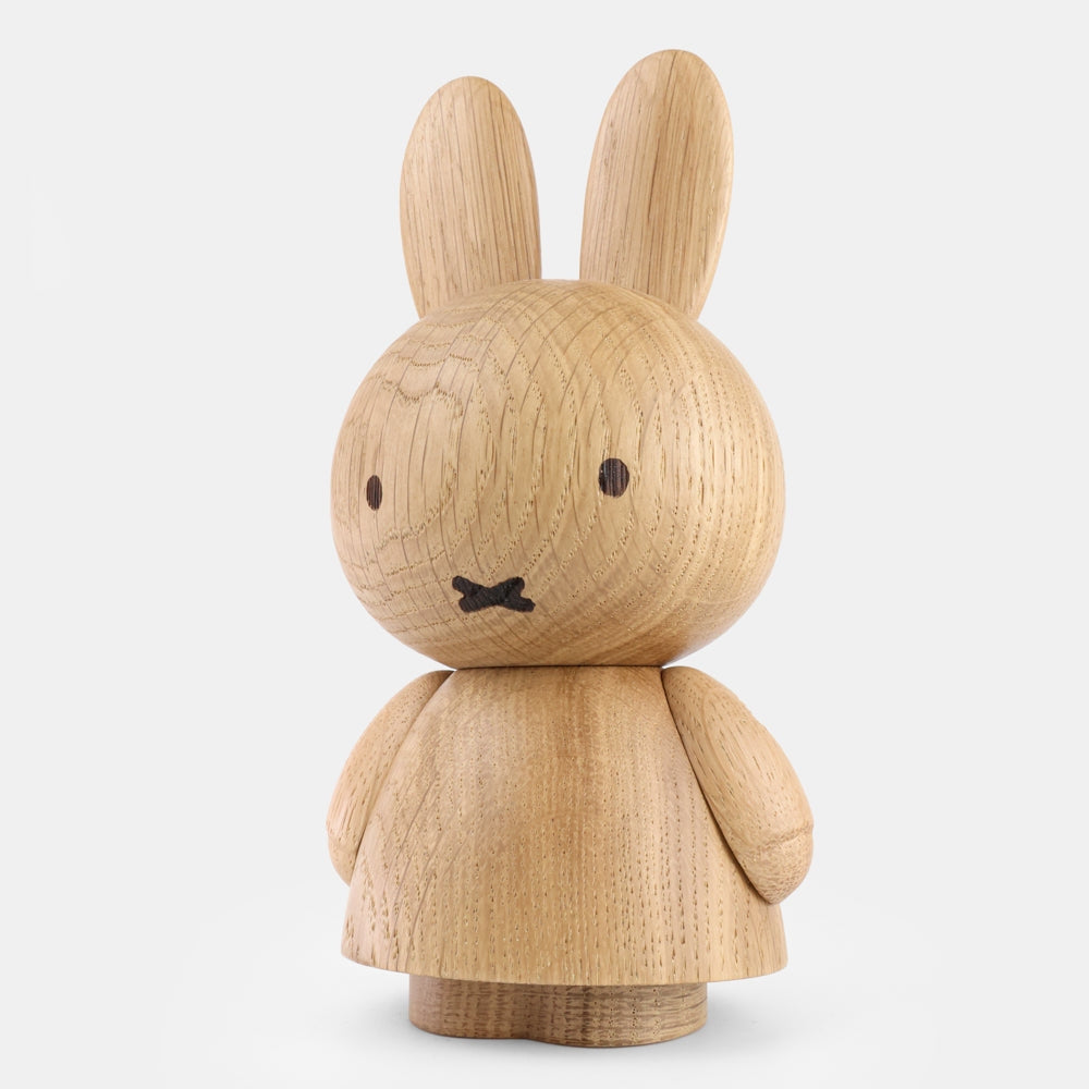 Mini oak wood bunny figurine with bow detail, rounded body, side view